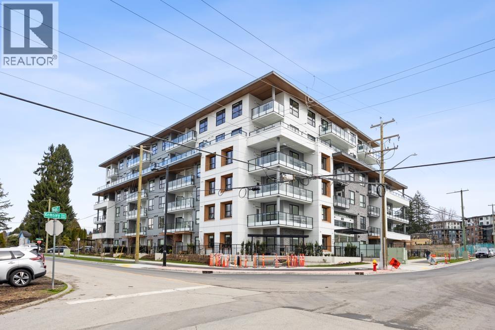 A large apartment building with a REALTOR® sign on the top left corner.