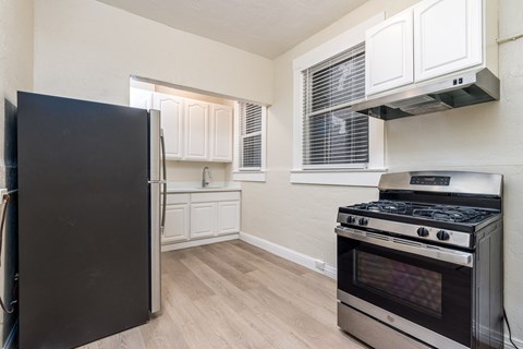 A kitchen with a black fridge and stove.