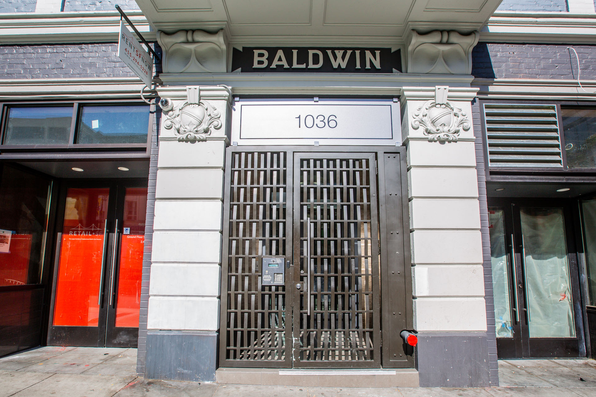 The front of a building with a large gate and a sign that reads "BALDWIN 1036".