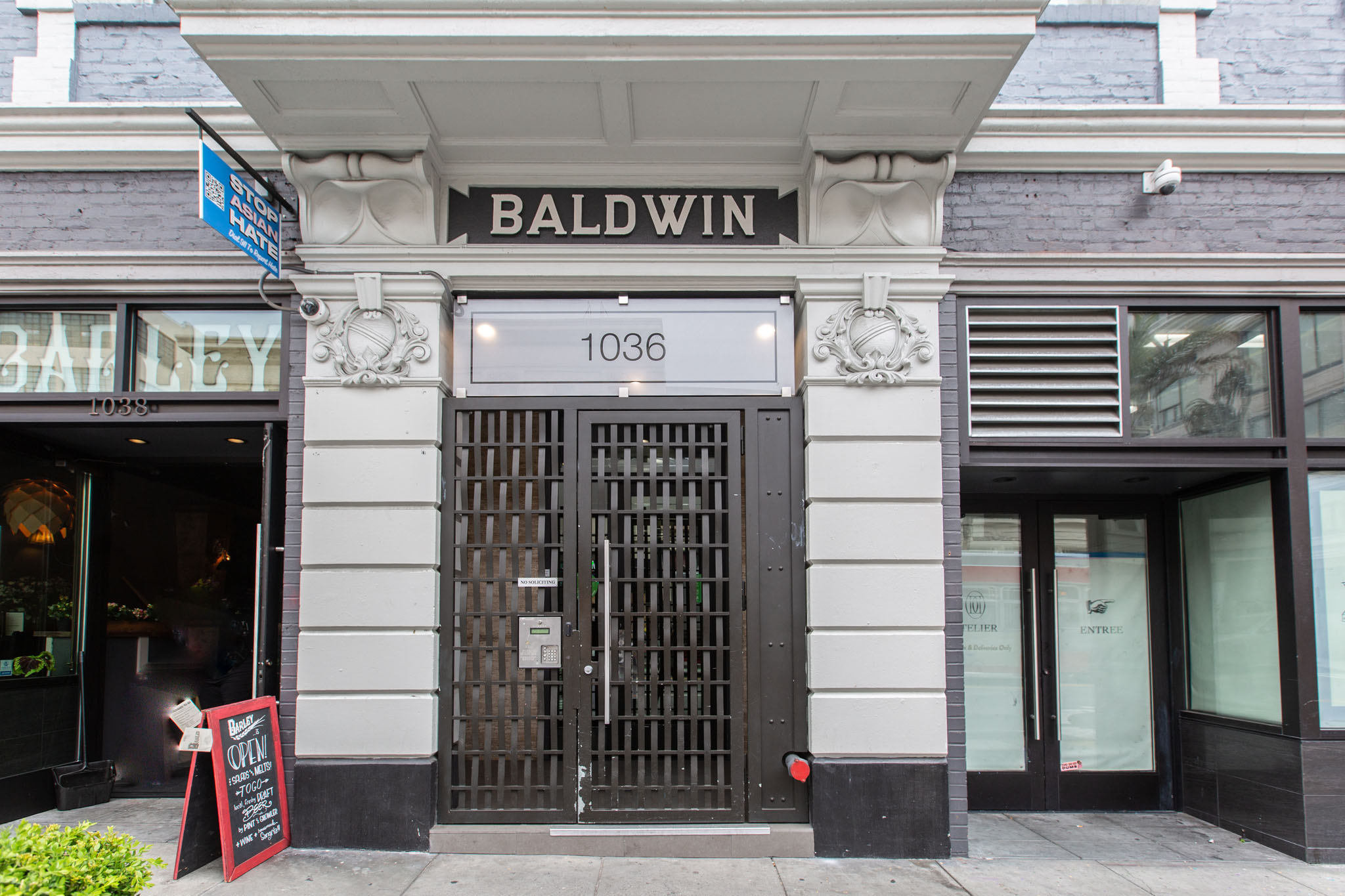 The front of a building with a black door and a sign that says Baldwin.