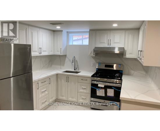 A kitchen with white cabinets and stainless steel appliances.