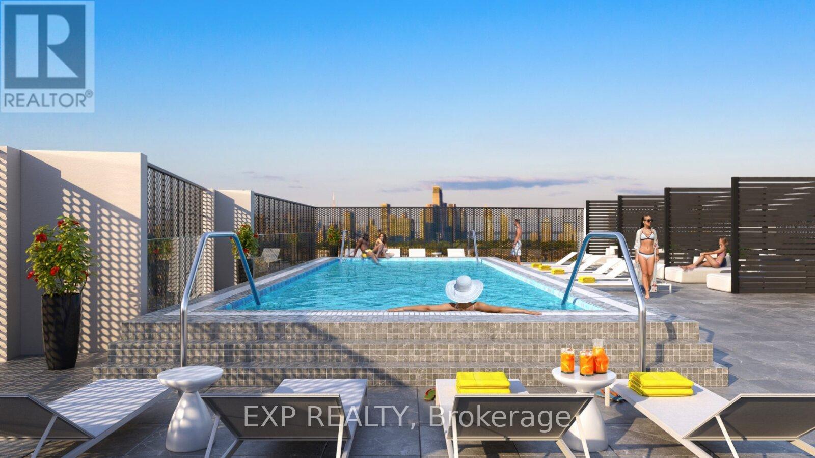 A pool with a slide and a sun lounger.