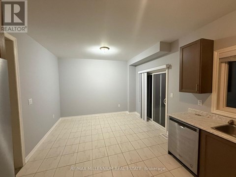 A kitchen area with a sink, dishwasher, and a window.