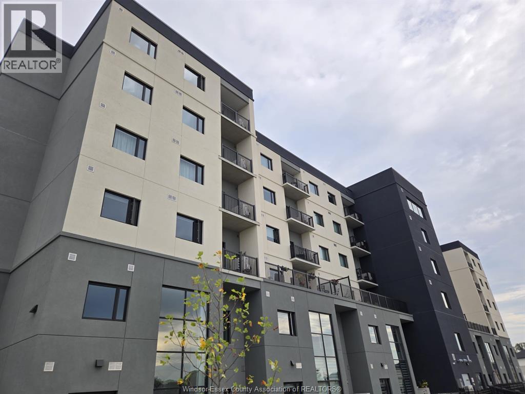 A modern apartment building with balconies and multiple windows.