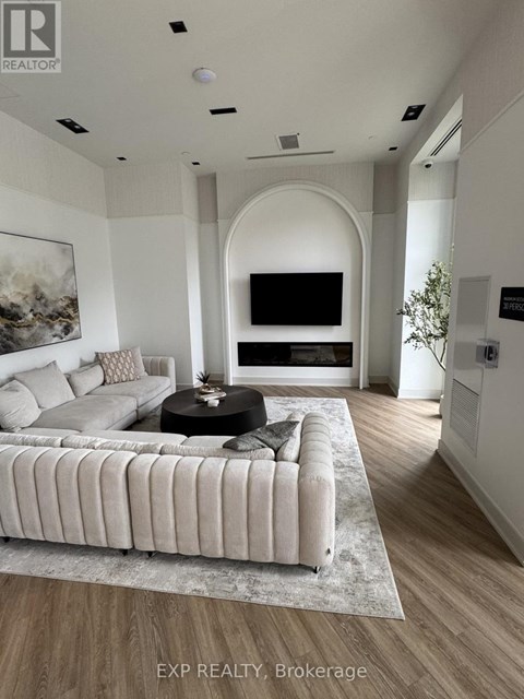 A living room with a large couch and a television.