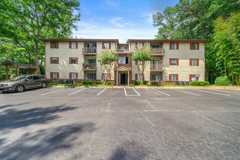 an empty parking lot in front of an apartment building