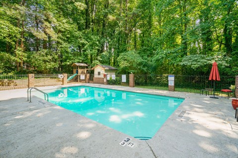 the swimming pool at the retreat at thousand oaks apartments with a resort style pool