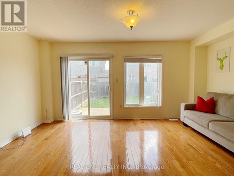 A living room with a couch and sliding glass doors.