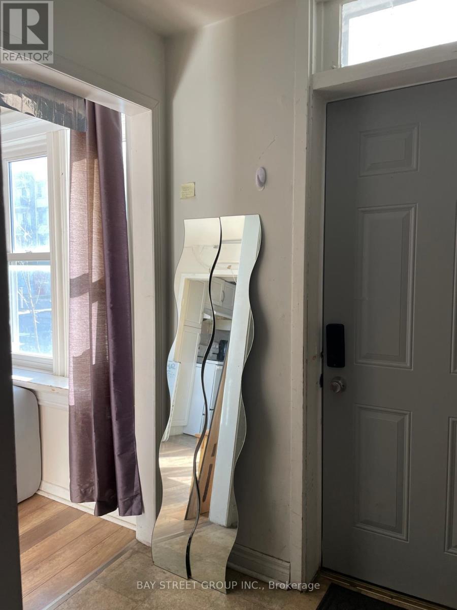 A white ladder is leaning against a wall next to a door.