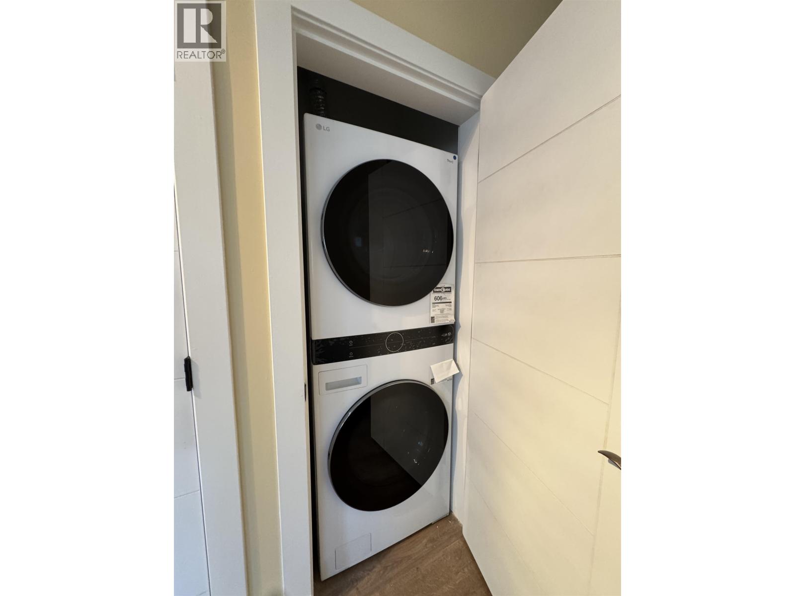 A washing machine is built into a wall in a laundry room.