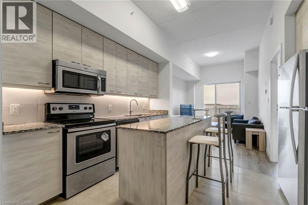 A modern kitchen with a stove top oven and microwave above it.