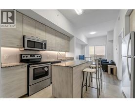 A modern kitchen with a stove top oven and microwave above it.