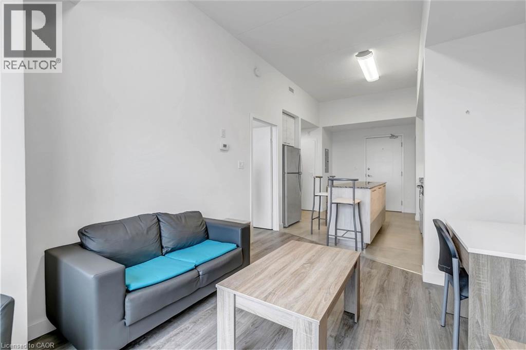 A grey couch with a blue cushion is in the living room.