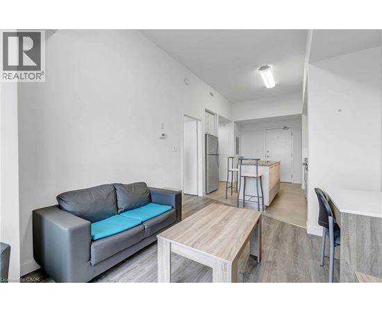 A grey couch with a blue cushion is in the living room.
