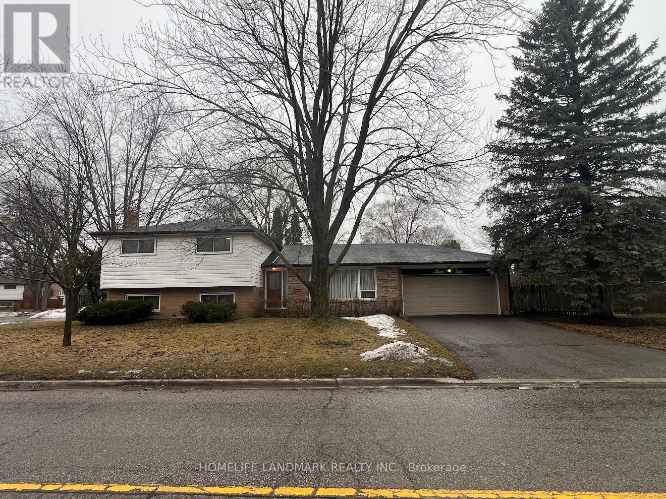 A house with a driveway in front of it.
