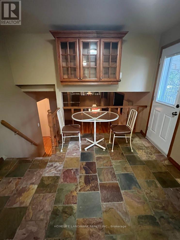 A dining room with a table and chairs.