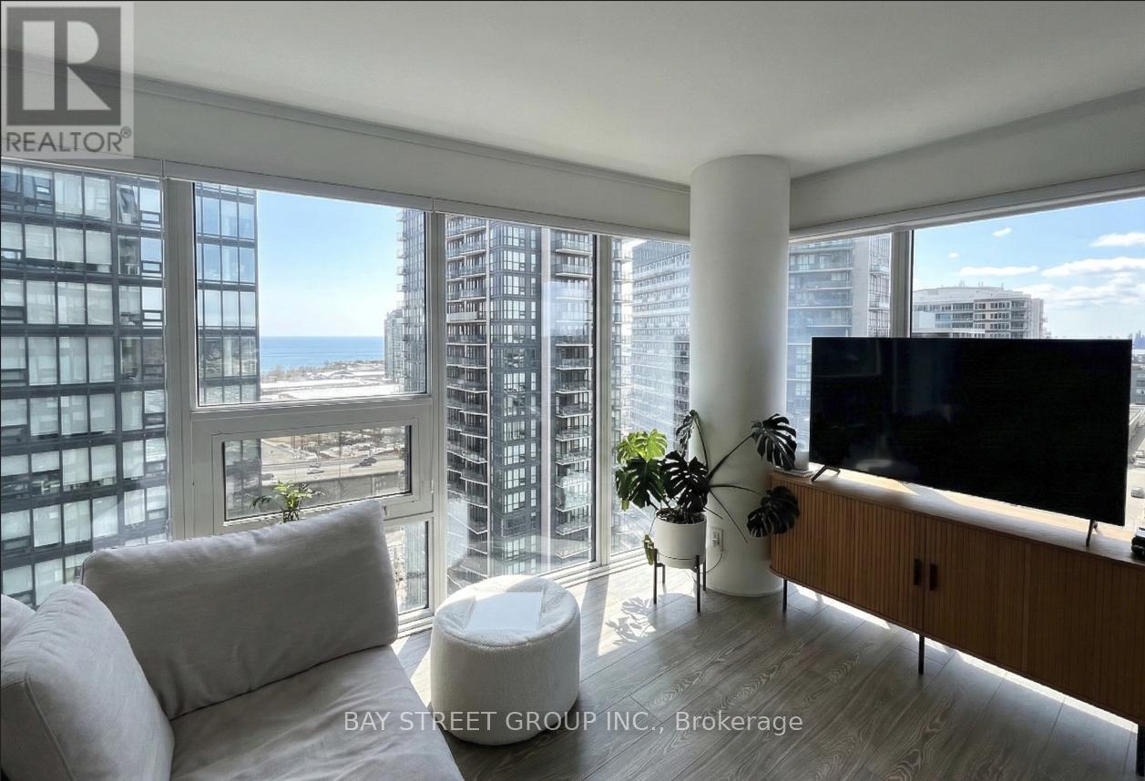A living room with a large window overlooking the city.