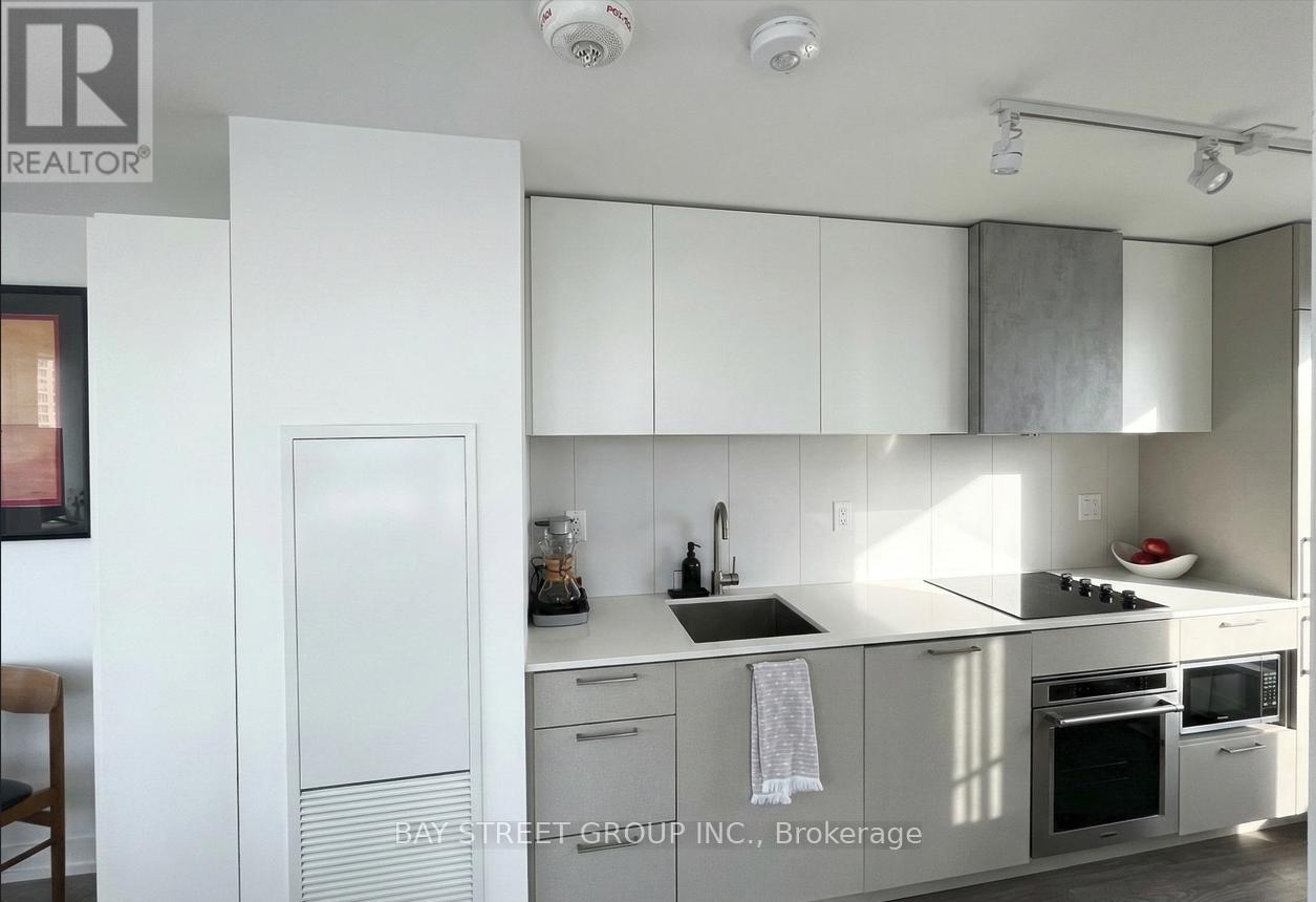 A kitchen with white cabinets and appliances.