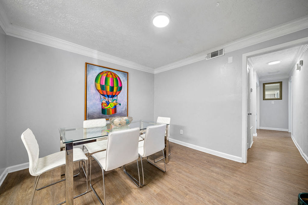 a dining room with a glass table and chairs