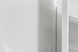 a white bathroom with a sink and a mirror