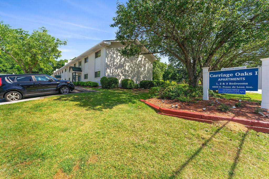 a car parked in front of a building with a sign