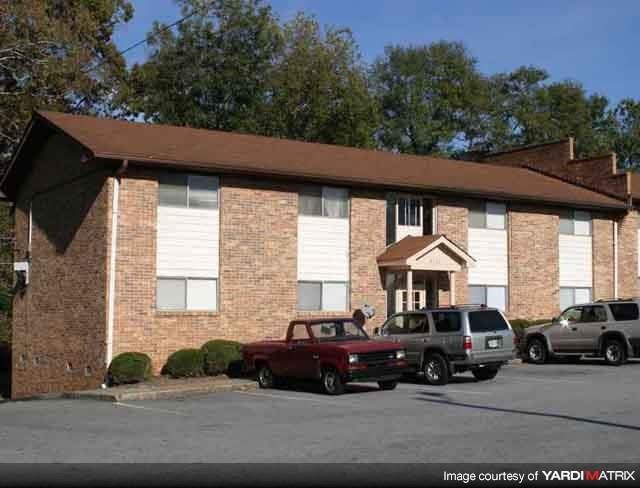a brick building with cars parked in front of it