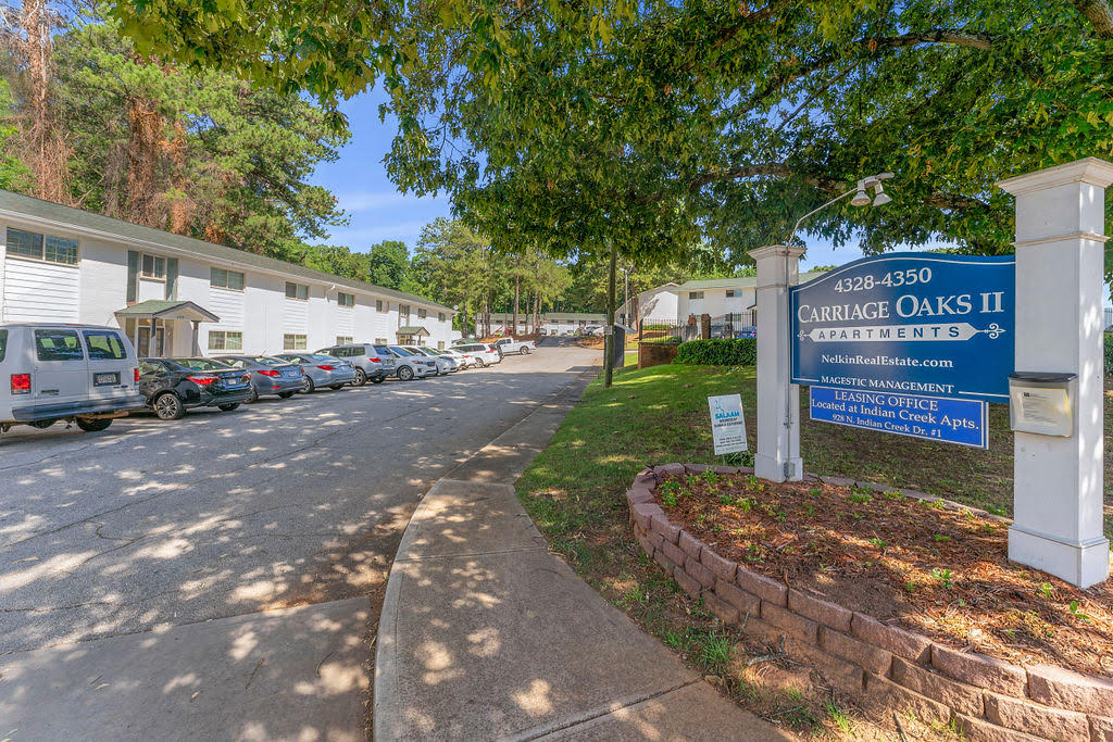a building with a blue sign and cars parked in front of it