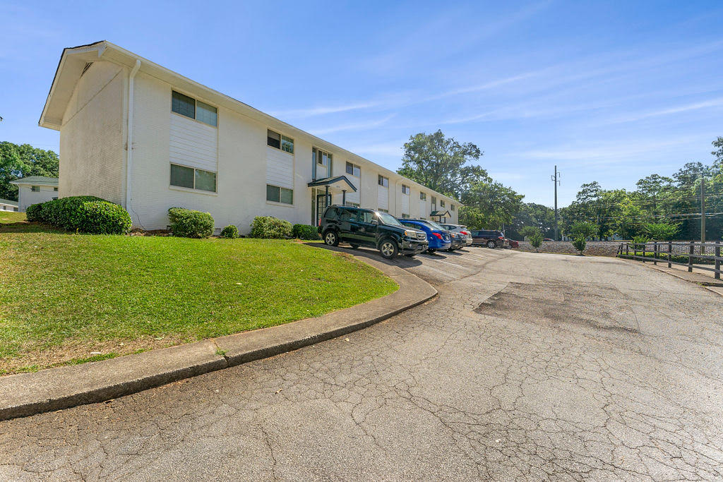 a large white building with cars parked in front of it