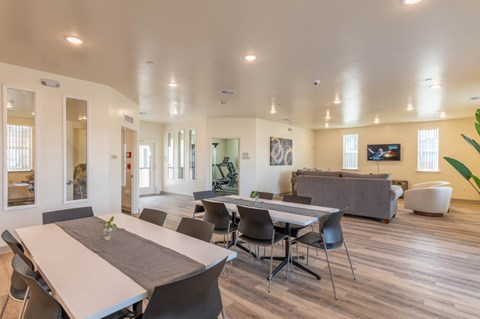 A dining room with a long table and chairs.