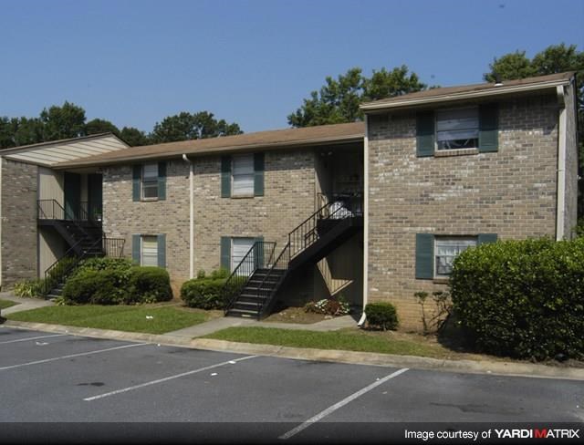 a brick apartment building with stairs