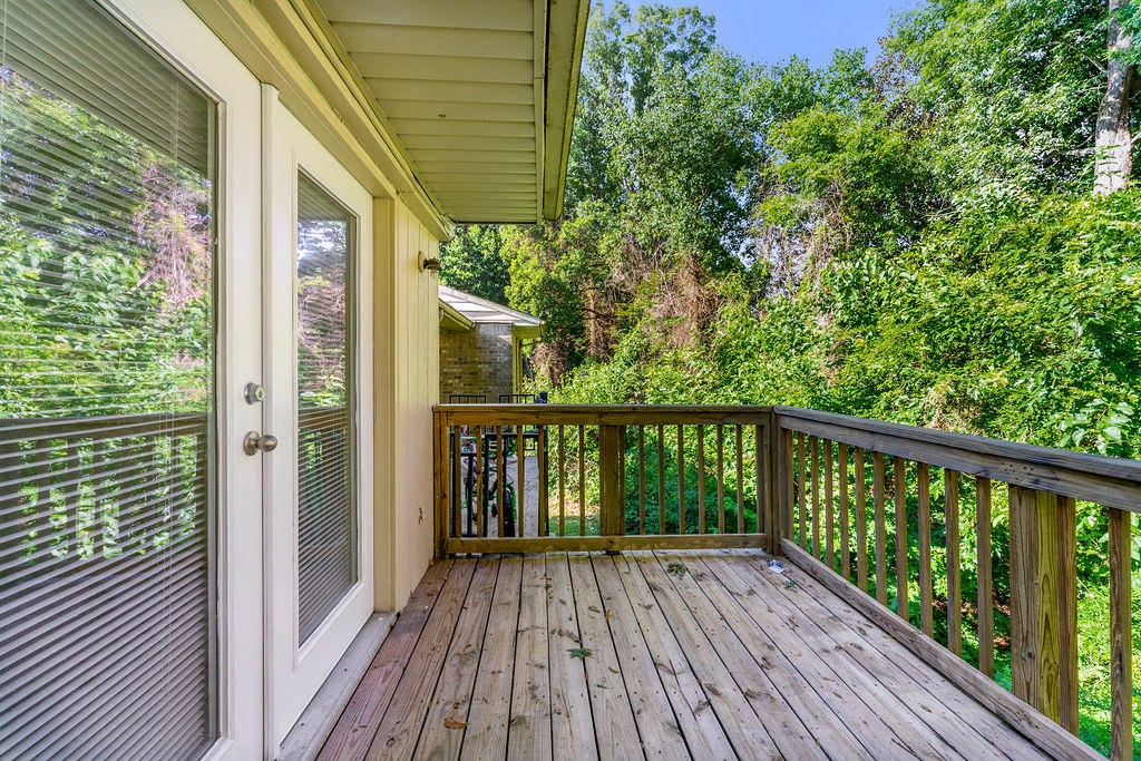 a balcony with a view of trees and a house
