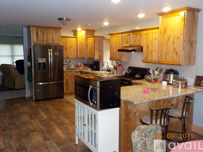 A kitchen with wooden cabinets and a black stove top oven.