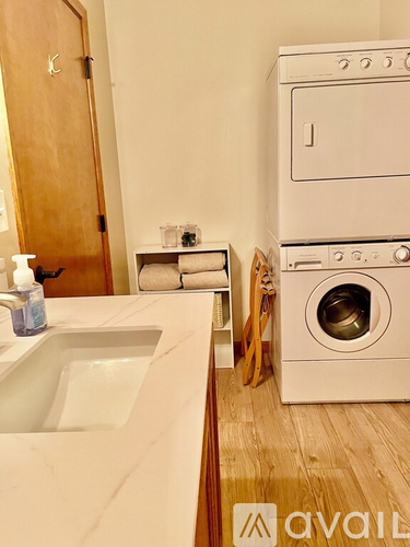 A white oven and washing machine in a kitchen.