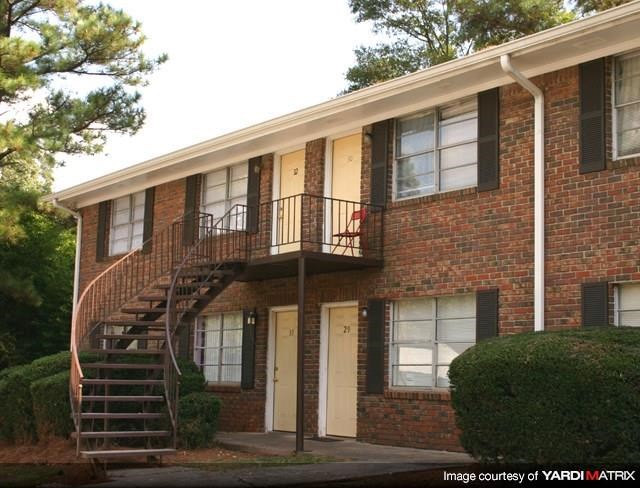 a brick apartment building with a spiral staircase