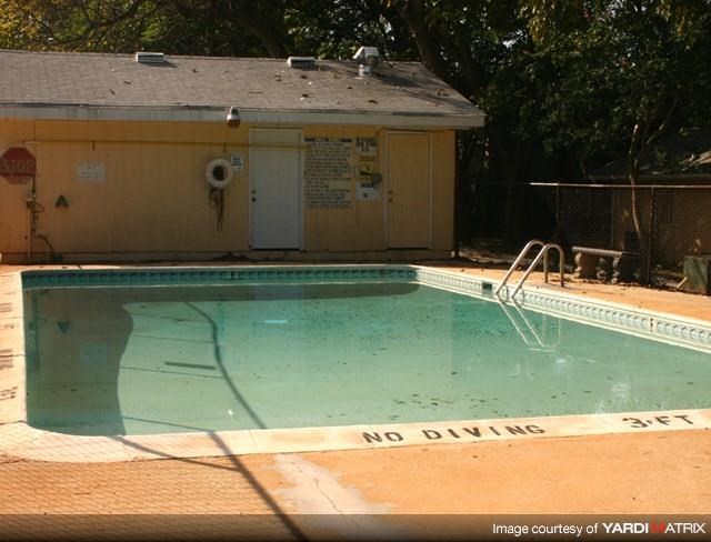 a swimming pool with a no diving sign on the side of it