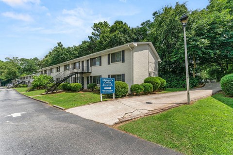 a white building with a blue sign in front of it