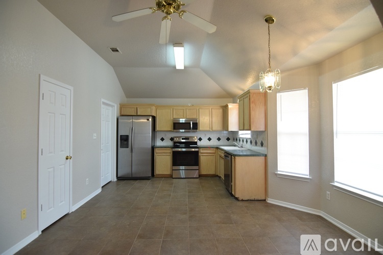 A kitchen with a refrigerator, stove, and oven.