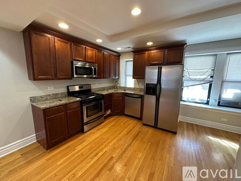 A kitchen with wooden cabinets and stainless steel appliances.
