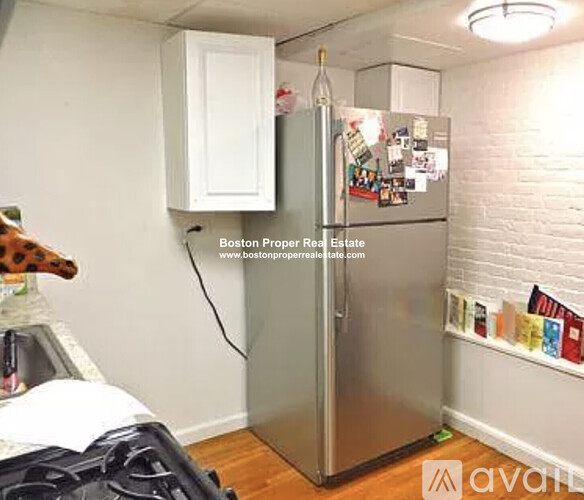 A small kitchen with a refrigerator covered in magnets.
