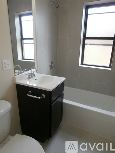 A bathroom with a toilet, sink, and bathtub.