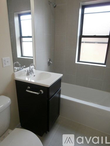 A bathroom with a toilet, sink, and bathtub.