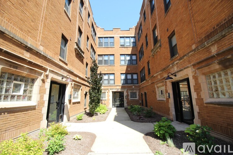 A brick building with a walkway between the buildings.