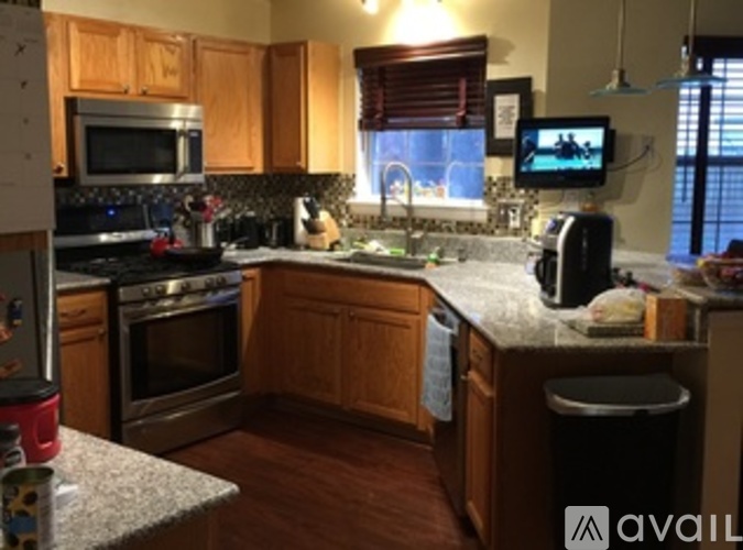 A kitchen with wooden cabinets and granite countertops.