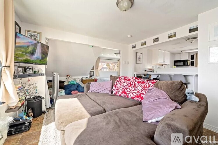 A living room with a grey couch and a white ceiling.