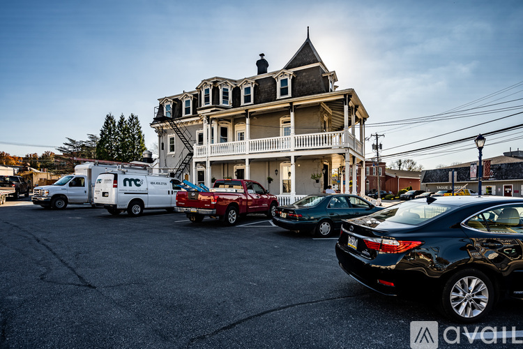 A large house with a car parked in front of it.