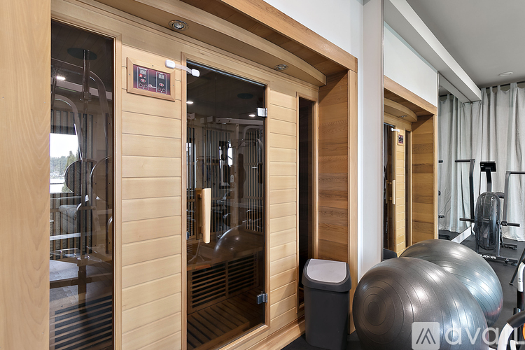A gym with a wooden wall and a glass door.