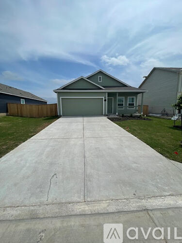 A house with a driveway in front of it.