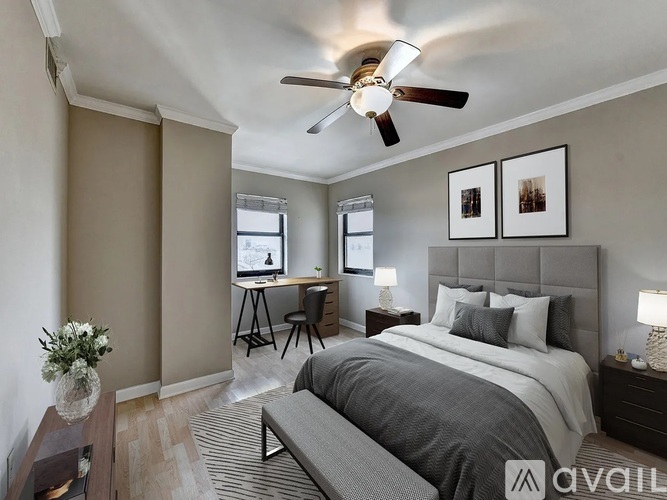 A bedroom with a bed, desk, and chair.