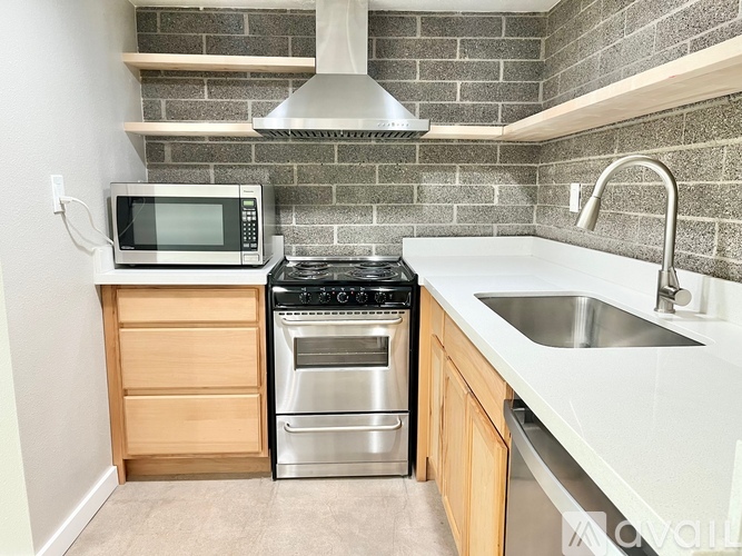 A kitchen with a stove top oven and microwave.