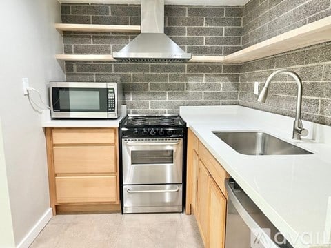A kitchen with a stove top oven and microwave.